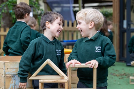 two young pupils from Nunney first school looking and laughing at each other
